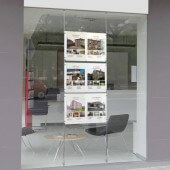 Floor to ceiling cables used within an estate agent's window display