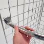 These curved clothes rails slot onto grid mesh panels in seconds