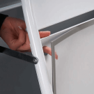 Pavement sign graphics securely held in place using magnetic covers