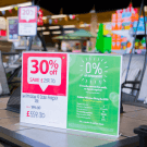 Place acrylic poster holders directly on large items to display prices
