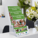 Counter standing leaflet dispenser displaying life insurance flyers