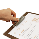 Wooden board with metal clip grip to keep paper menus secure