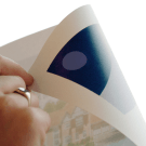 Double sided sticky dots securing displays of signs and posters