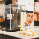 A gold frame acrylic sign holder adds a luxury aesthetic
