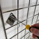 Simply screw the grid mesh wall mounting brackets into your wall to secure