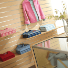 Wood slatwall with silver inserts, shelves and clothes rails