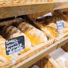 Shallow wicker tray ideal for displaying food in bakeries and delis