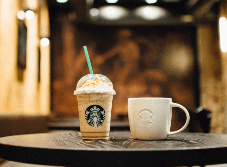 Ceramic and plastic cups featuring the Starbucks logo, demonstrating the power of branding your business