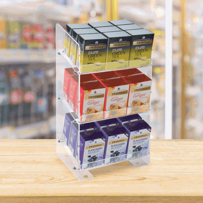 Three Tier Acrylic Merchandising Display displaying teabags on a supermarket counter