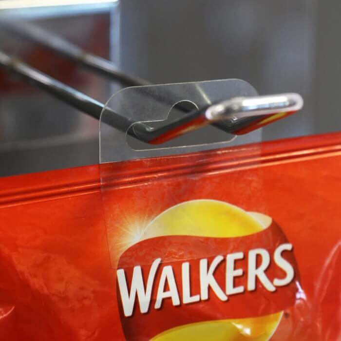 self adhesive hang tabs displaying crisps on a merchandising hook
