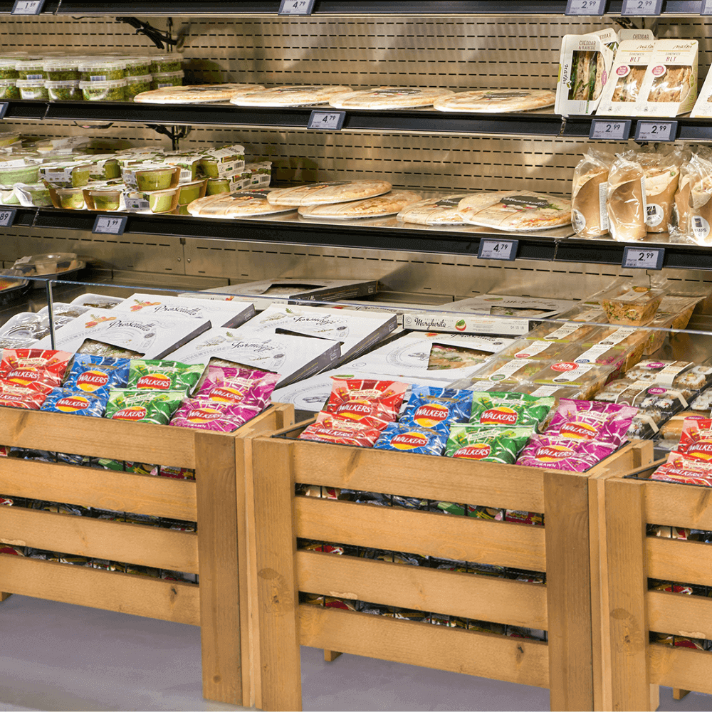 wooden crate dump bin displaying crisps in meal deal supermarket section