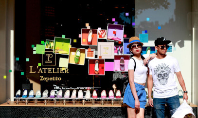 Young couple posing next to colourful shop window