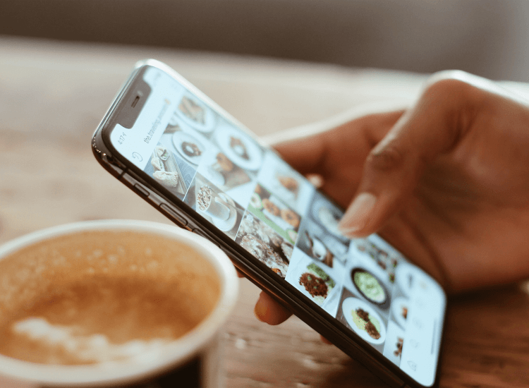 Consumer browsing social media in a cafe, integrating online and offline marketing