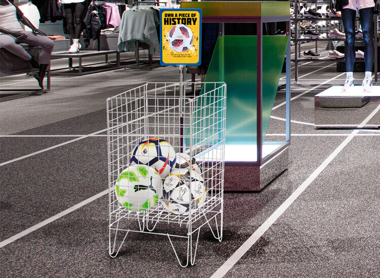 dump bin displaying footballs in a sports retail store