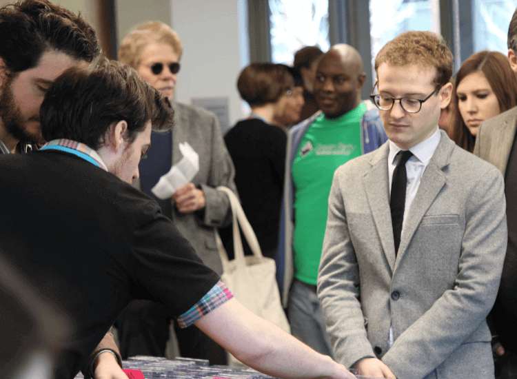 Man waiting to be served at the front of a queue