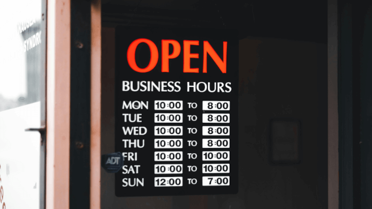 window poster holder showing opening hours