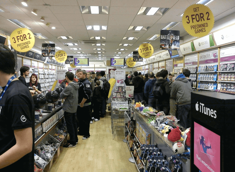 Queue in a game store with overhead promotional signage