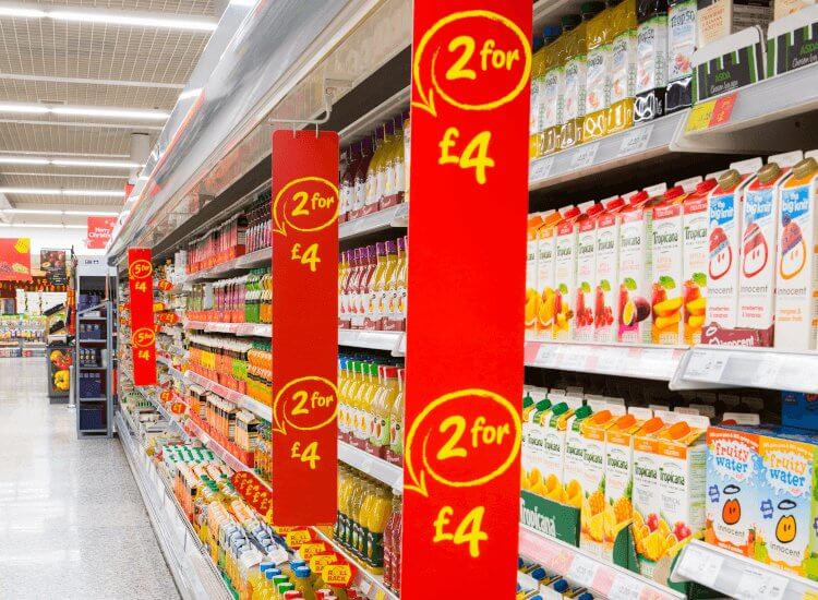 Red aisle signs over supermarket shelving