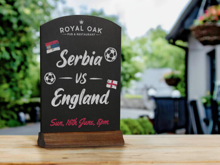 tabletop chalkboard sign displaying a world cup match time