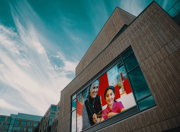 Digital display board ideas 1: family pictured on an outdoor digital screen