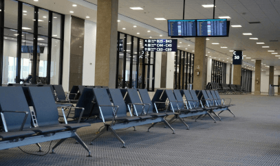 Waiting area with chairs and a digital screen